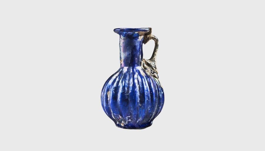 A Roman blue ribbed glass jug. Second half...