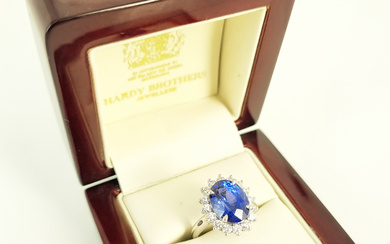 A SAPPHIRE AND DIAMOND RING: oval sapphire (12