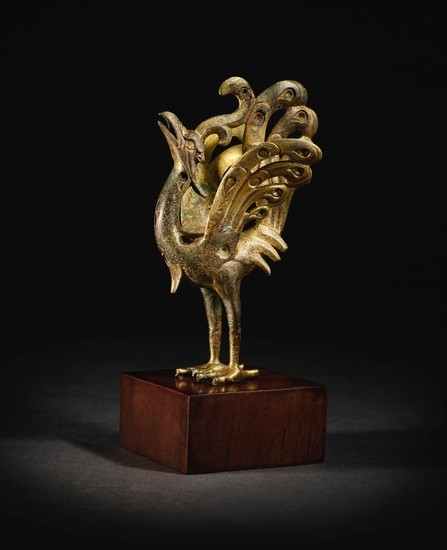 A SPLENDID AND RARE GOLD AND SILVER-INLAID PARCEL-GILT BRONZE FIGURE OF A PEACOCK HAN DYNASTY