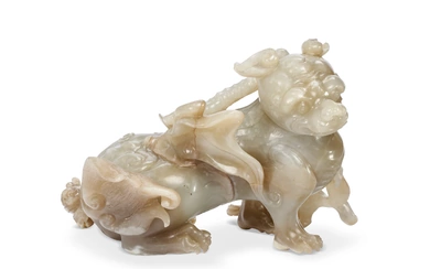 A WHITE AND BROWNISH-GREY JADE FIGURE OF A SEATED MYTHICAL BEAST CHINA, QING DYNASTY (1644-1911)