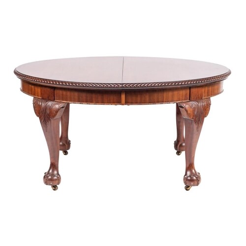 A carved mahogany oval dining table in the George II taste, ...