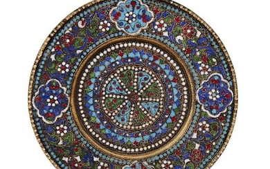A cloisonné enamelled dish, probably Russian, late 19th century, the reverse with spurious marks (stamped only 84 and Cyrillic KF (КФ)), the circular dish designed with concentric rings of blue and white enamelled pellets bordering variously...