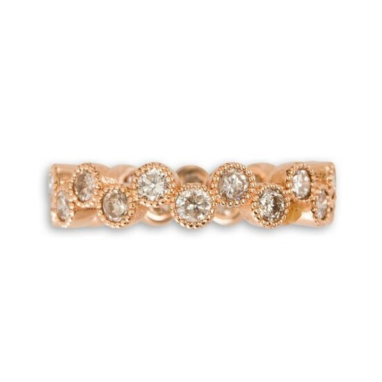 A diamond and eighteen karat rose gold band ring