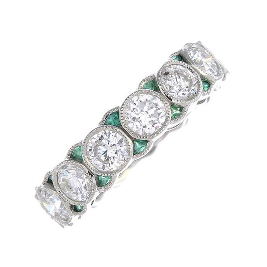 A diamond and emerald full eternity ring. The