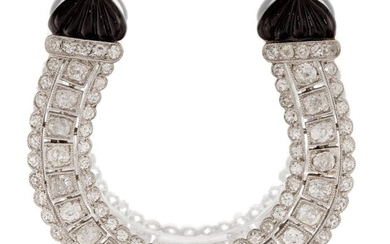A diamond and onyx horseshoe clip brooch, set with a triple row of old-brilliant-cut diamonds, in pierced mount to domed melon-cut black onyx terminals, clip fitting, approx. width 3.9cm (VAT charged on hammer price)
