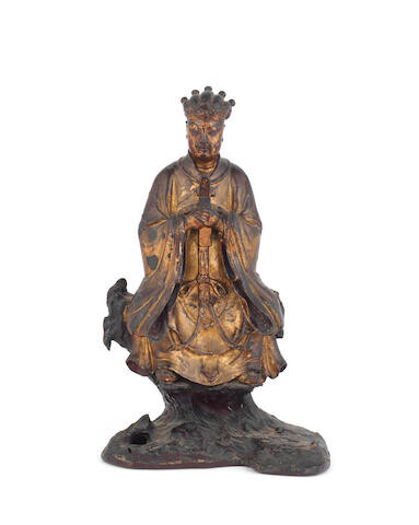 A gilt and lacquered wooden figure of an official on bronze stand