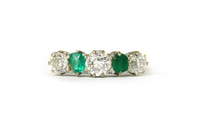 A gold diamond and emerald five stone ring