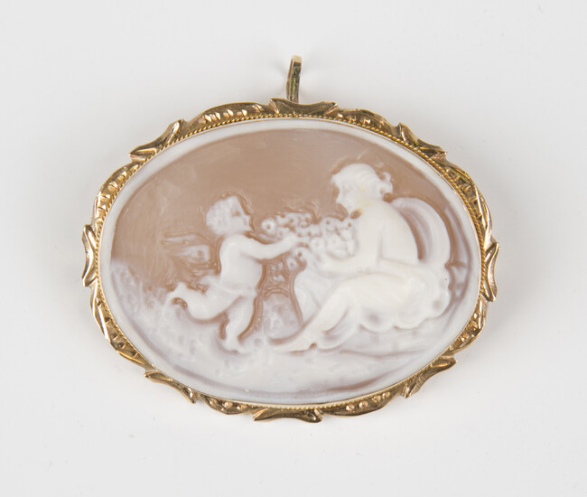 A gold mounted oval shell cameo pendant brooch, carved as a maiden with Cupid, the shaped surround w