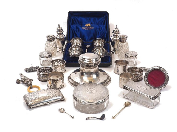 A group of silver comprising: a cased set of four silver salt cellars and two salt spoons, London, c.1899, Josiah Williams & Co.; four Victorian silver mounted vanity jars, London, c.1868/9 (one later), Thomas Whitehouse, all with crest and...
