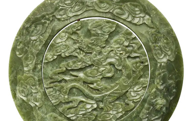 A large Chinese spinach jade 'dragon' circular plaque, 20th century, the central...