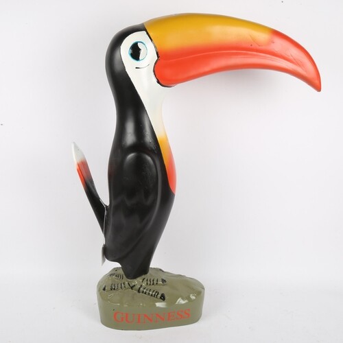 A large modern Guinness Toucan advertising figure, hand pain...