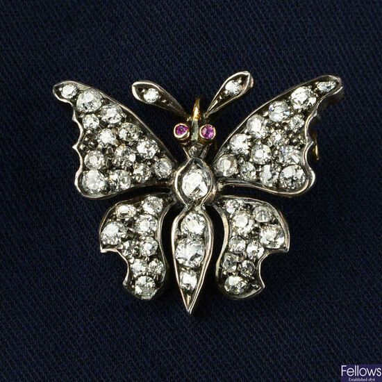 A late 19th century silver and 15ct gold, old-cut diamond butterfly brooch, with ruby eyes.
