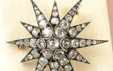 A late Victorian silver and gold, old-cut diamond star brooch/pendant.