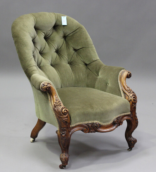 A mid-Victorian walnut tub back armchair, upholstered in buttoned green velour, on carved cabriole l
