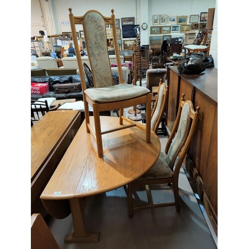 A modern Ercol light oak dining table with drop leaf and 4 c...