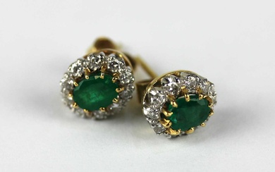 A pair of 18ct gold emerald and diamond oval cluster ear studs