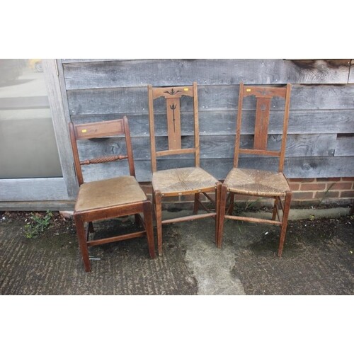 A pair of Arts & Crafts rush seat elbow chairs with triple s...