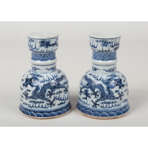 A pair of Chinese blue and white candle stands. Painted in u...