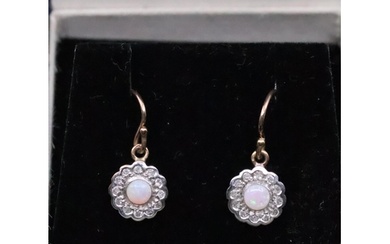 A pair of diamond and opal earrings set in 9ct gold