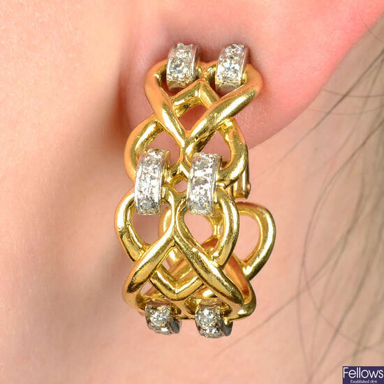 A pair of interlocking heart earrings set with single-cut diamond highlights.