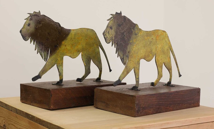 A pair of painted folk art lions