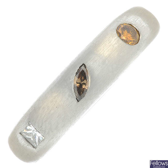 A platinum vari-cut diamond and 'brown' and 'yellow' diamond band ring.