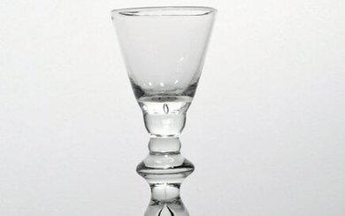 A rare baluster wine glass c.1725, with rounded funnel bowl...
