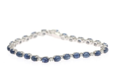 A sapphire and diamond bracelet set with numerous cabochon sapphires and numerous diamonds, mounted in 18k white gold. L. 18 cm.