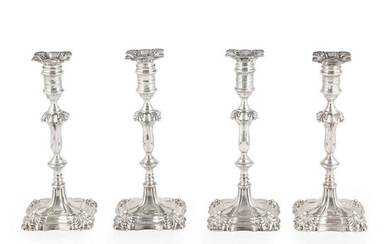 A set of four Edwardian table candlesticks