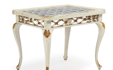 A white- and gold-painted wood Rococo style tile table, top with 35 Dutch faience tiles. 19th century H. 82. L. 100. W. 74 cm.