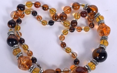 AN AMBER TYPE NECKLACE, formed with white metal
