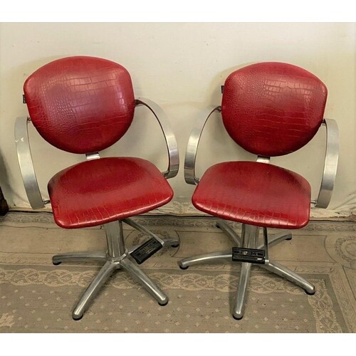 AN UNUSUAL PAIR OF VINTAGE BARBER CHAIRS, with lever for adj...
