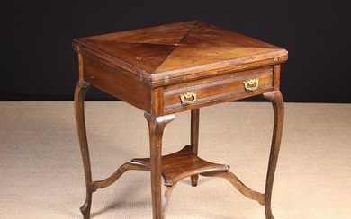 An Edwardian Walnut Envelope-top Card Table. The square top having hinged triangular flaps folding o