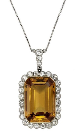 An Edwardian citrine and diamond pendant/brooch, centring on a rectangular cut-cornered citrine framed by millegrain set circular-cut diamonds with similarly set suspension to a trace link chain, length 40cm, fitted case, diamond suspension and...