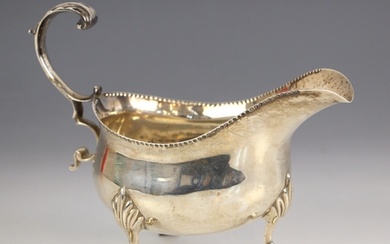 An Edwardian silver sauce boat, ‘TS’ London 1903, the flying...