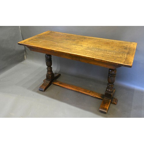 An Oak Refectory Style Dining Table, the plank top above twi...
