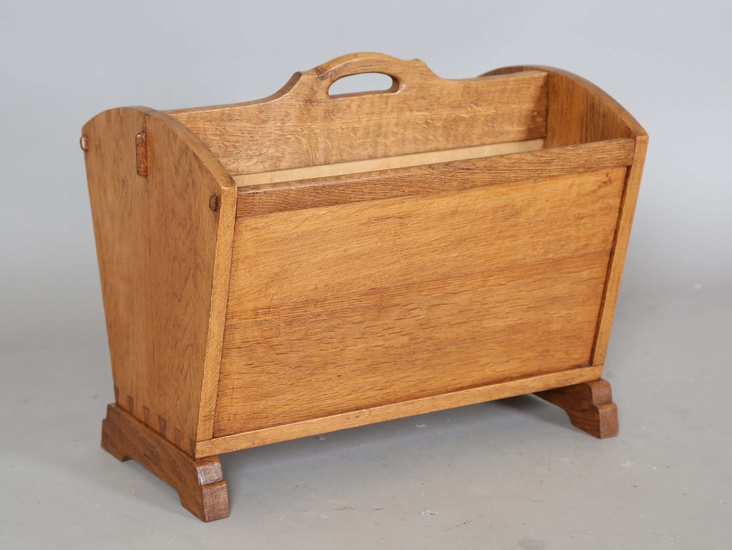 An early 20th century Cotswold School oak two-division magazine rack, the ends with show joint detai
