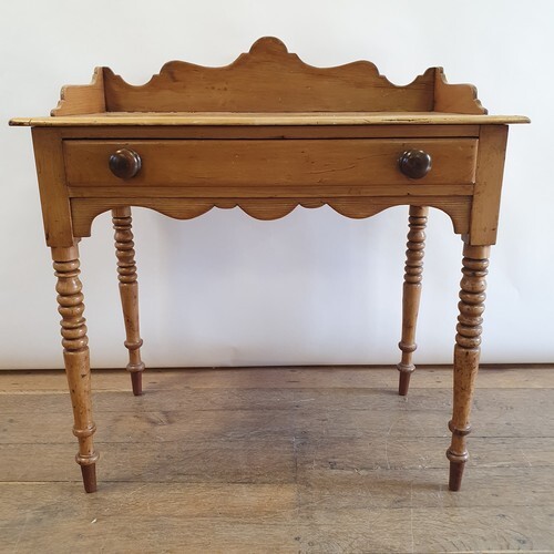 An early 20th century pine side table, with a single frieze ...
