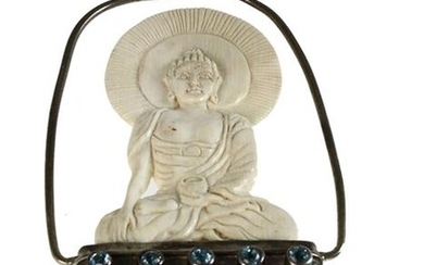 Asian carving - A carved Buddha of mammoth bone (height c. 50 mm.), framed as a pendant, with 3 small rock crystals and 5 polished pieces of topaz.