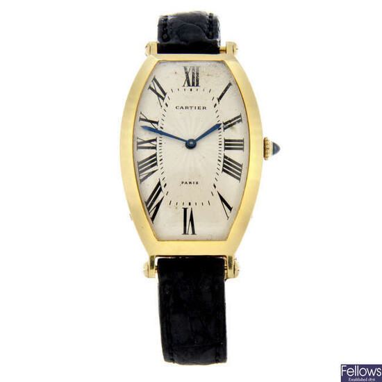 CARTIER - a yellow metal Tonneau wrist watch, 26x39mm.