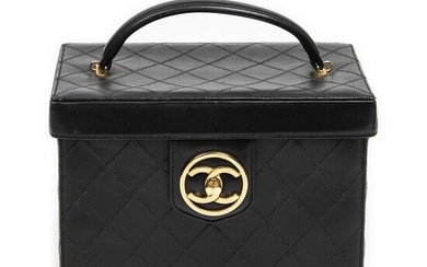 Chanel A “CC Logo Vanity Bag” of black quilted leather with gold...