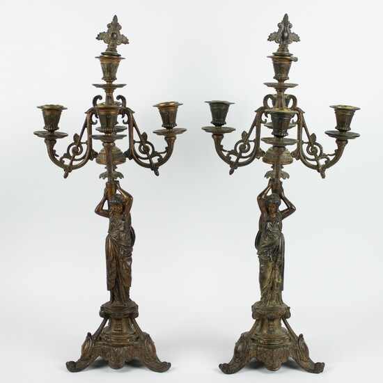 Couple of candlesticks with pillars as a caryatid