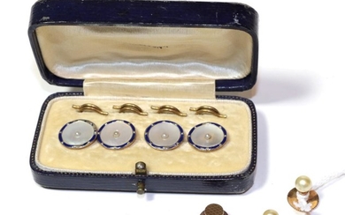 Four buttons comprised of mother of pearl, blue enamel and...