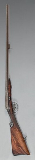 Shotgun system Montigny, central percussion by needle, double barrel in damascus steel table with tobacco-coloured ribbon, signed on the band in gold letters: "F. C. Montigny Bté à Fontaine l'Évêque", length 65 cm, calibre 17.5 mm; mobile breech...