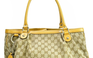 GUCCI; a black MM canvas and beige leather Sukey handbag,...