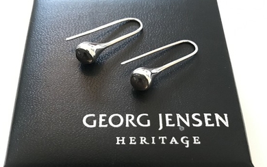Georg Jensen: A pair of “Droplet” ear pendants each set with a polished smoky quartz, mounted in sterling silver. Design 453. L. 2.6 cm. (2)