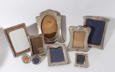 Large Edwardian silver photograph frame with reeded borders and oval photograph aperture (Birmingham 1905) together with a group of eight other silver photograph frames various dates and makers (9)