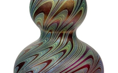 Loetz (Austrian), an iridescent Rubin Phaenomen double-gourd glass vase, 1899, PG 7624, ground out pontil, Red glass body, decorated with silvery-blue and green pulled banded threads on the diagonal, 22.5 cm high, Property from a private...
