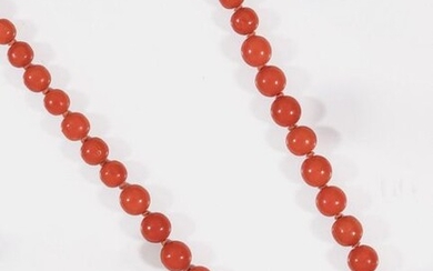 Necklace made of a string of falling coral beads. Yellow...