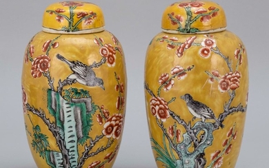 PAIR OF CHINESE FAMILLE ROSE PORCELAIN COVERED GINGER JARS Decorated with nightingales on flowering tree branches against a mustard...